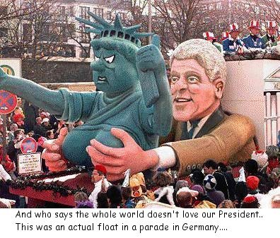 Former President Bill Clinton on a parade float in Germany holding the Statue of Liberty